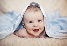 baby under blanket cognitive development in infancy