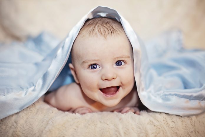 baby under blanket cognitive development in infancy