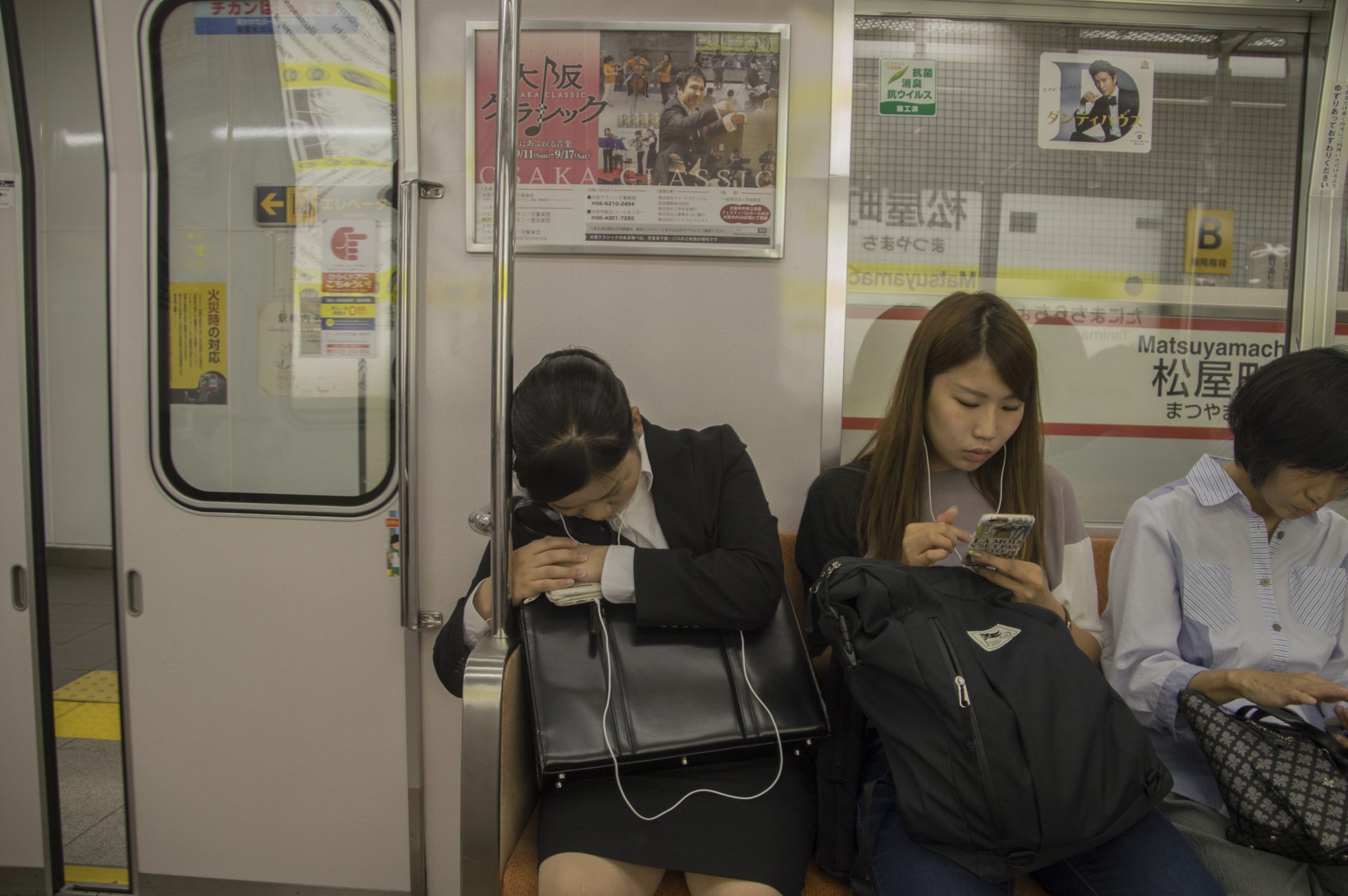 Japanese Woman Sleeping At An Osaka Subway Train At Japan 2016. 