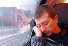 man napping on the train