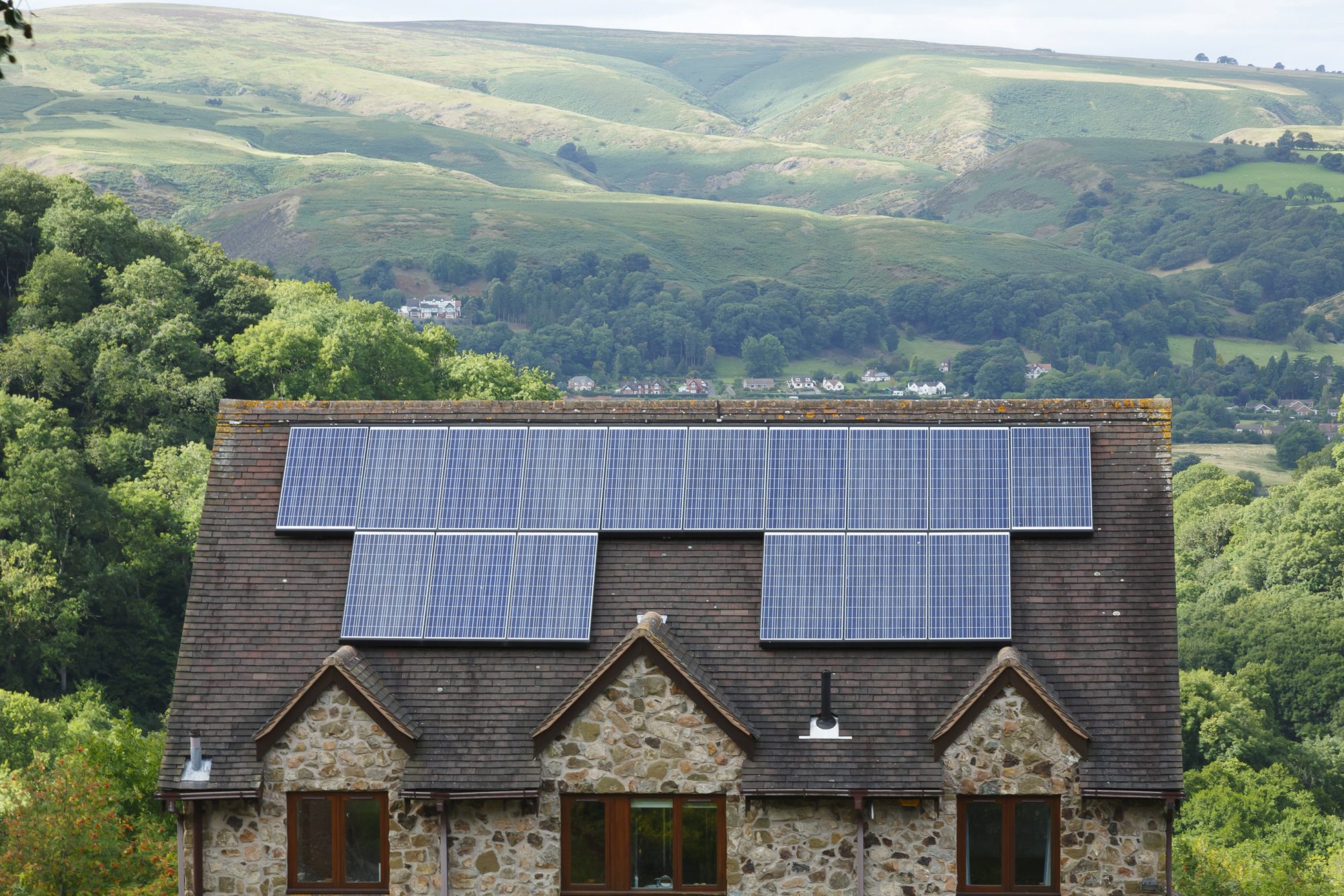 House in the UK with solar panels on top, net zero energy strategy