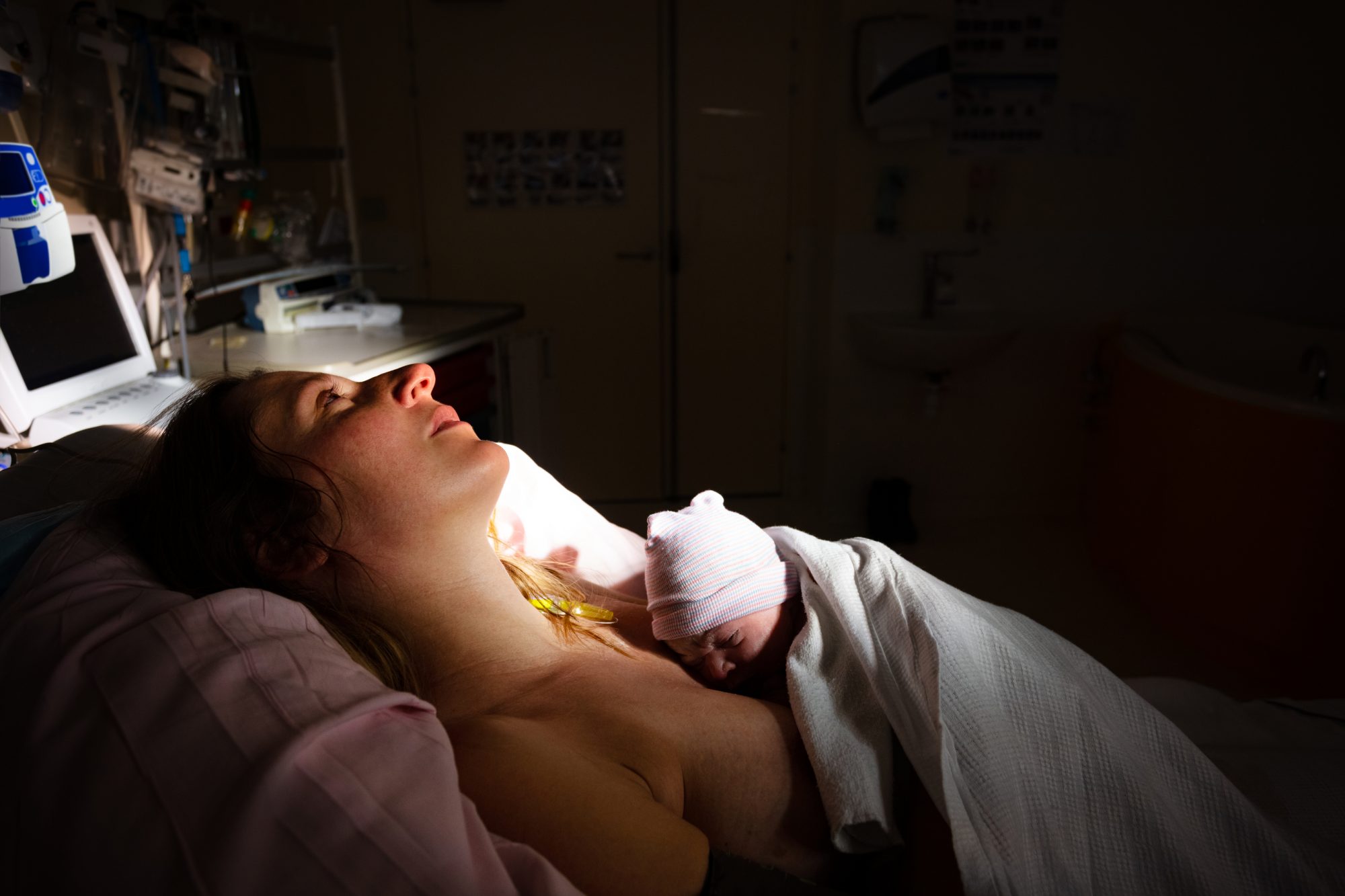 woman holding her new born baby in a doctor's office, health concept