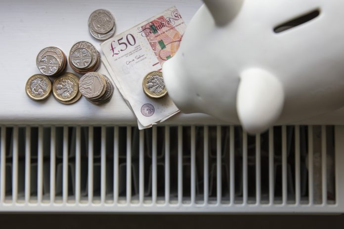 money on a radiator indicating expensive energy bills