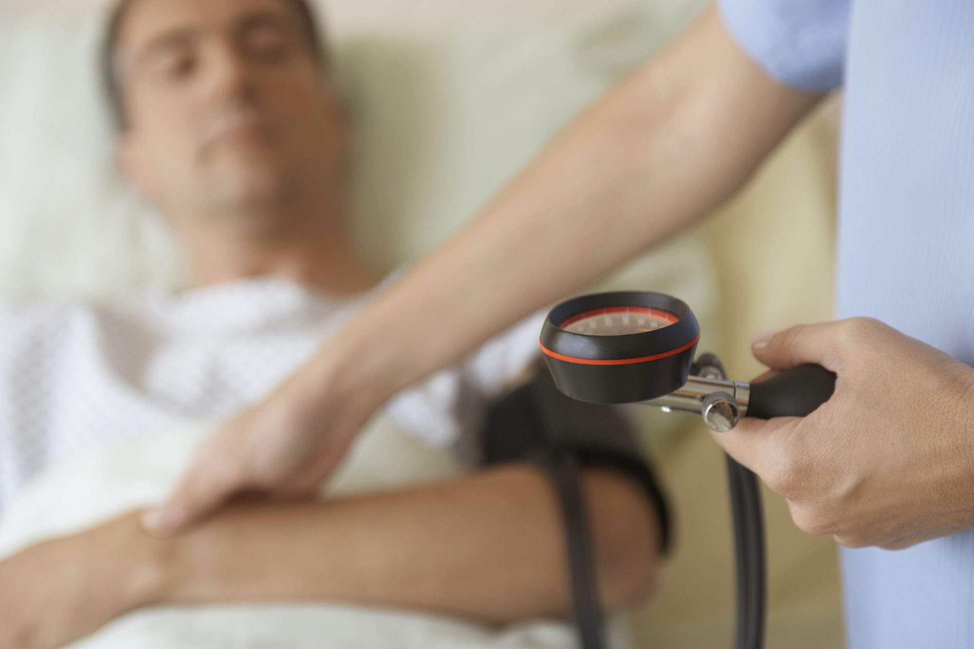 patient having their blood pressure checked by a screening doctor