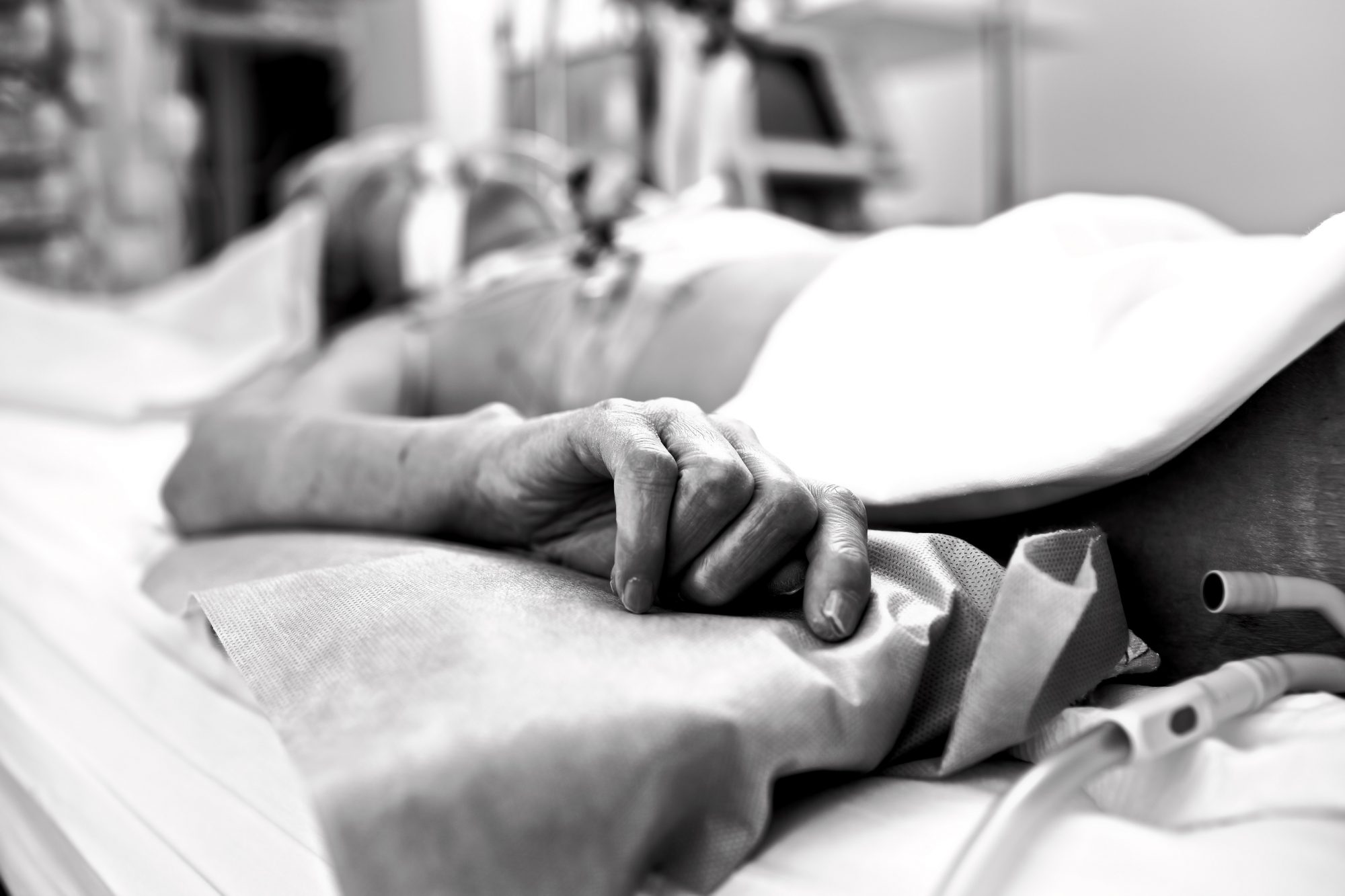 patient in hospital bed, using technology to keep them alive