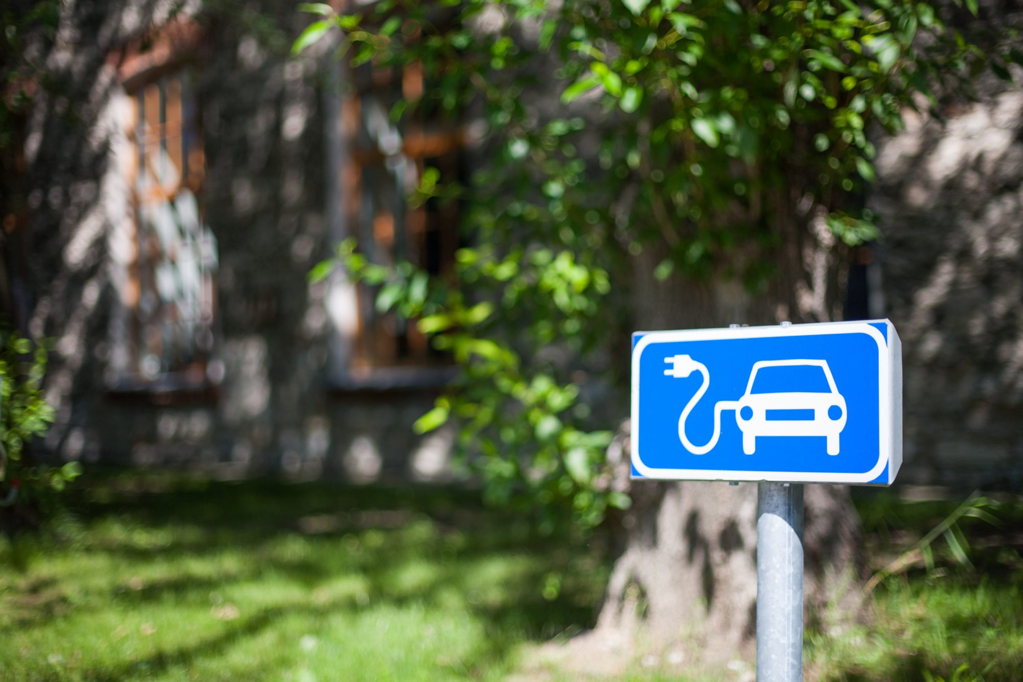 EV charging sign on a road