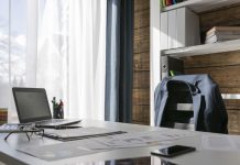 Empty office with suit jacket hung over back of chair