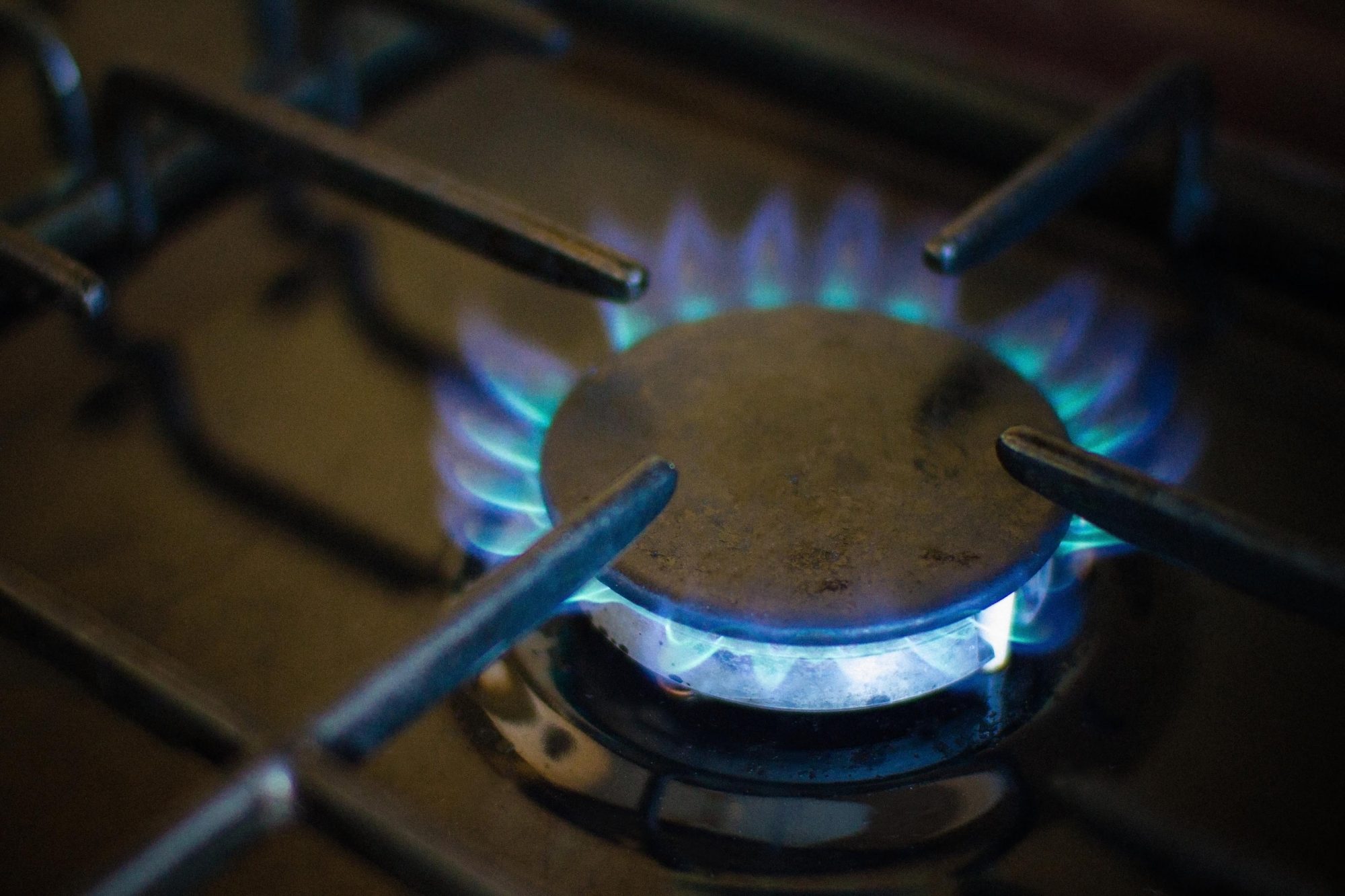 Black gas stove with blue flame