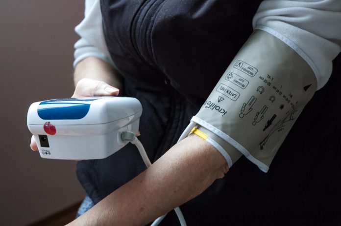 Woman taking her blood pressure