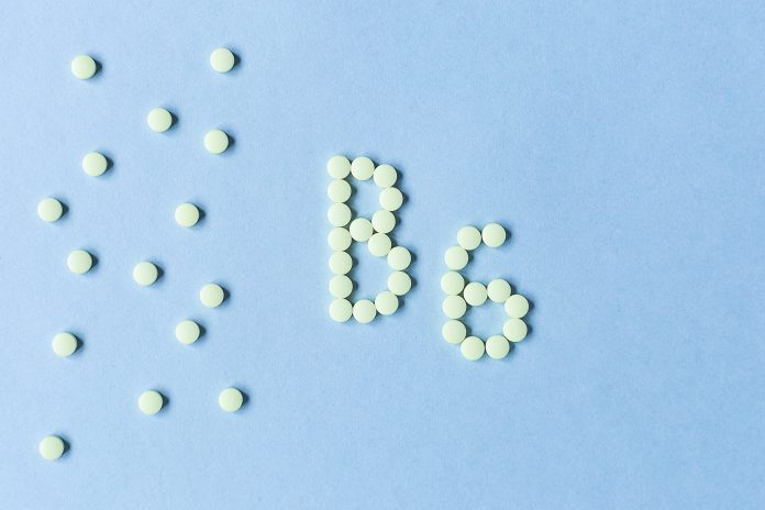 Vitamin B6 tablets forming the word 'B6' on a blue background