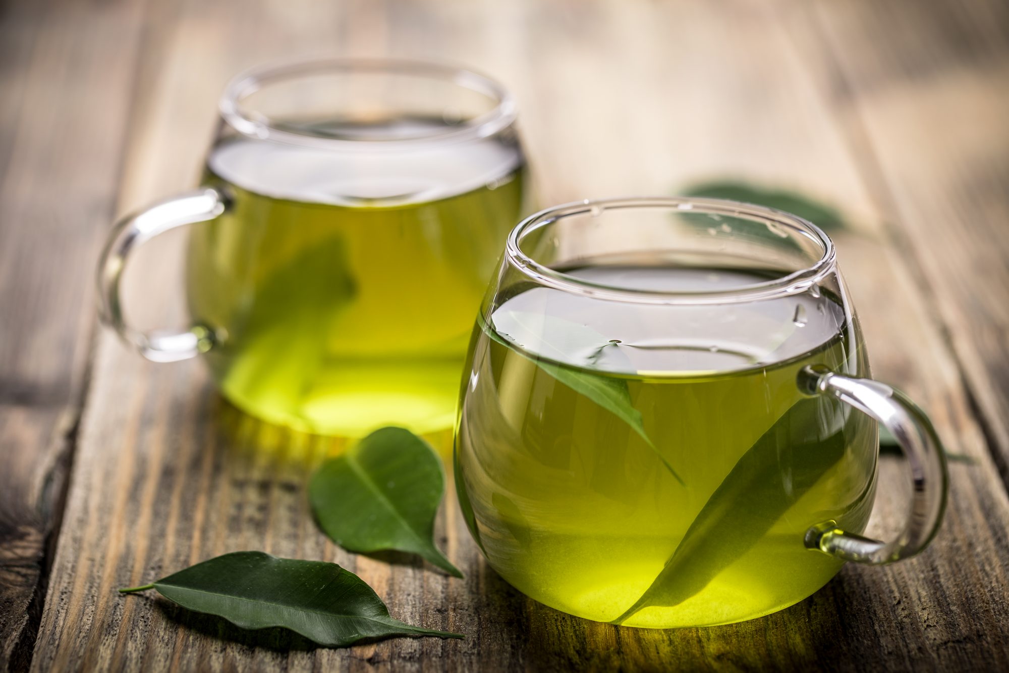 Glass cups filled with with green tea, good for gut health