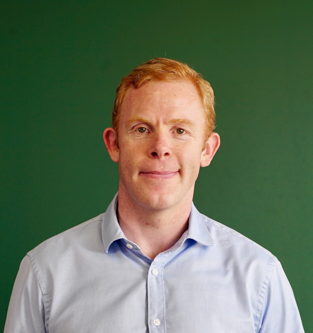 Portrait of Stuart Jubb against dark background