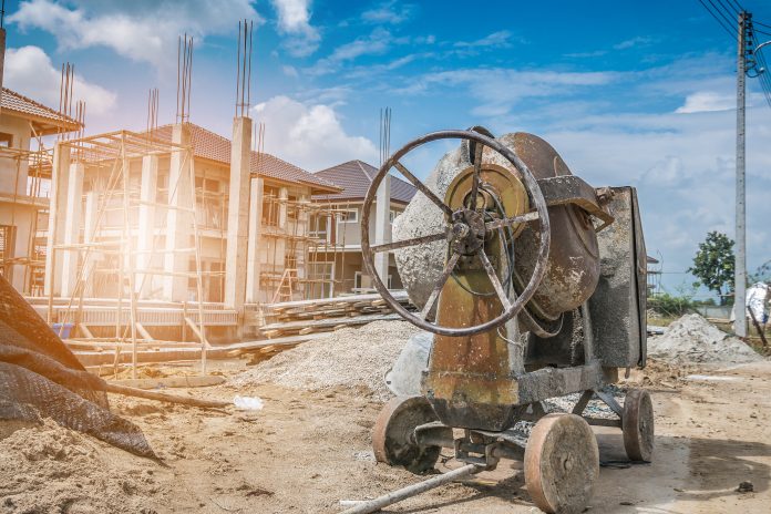 concrete mixer with construction background