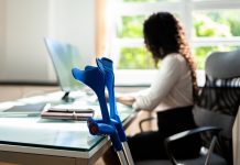 woman working with a physical health condition at office