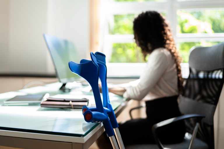 woman working with a physical health condition at office