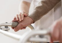 person assisting a patient with a disability