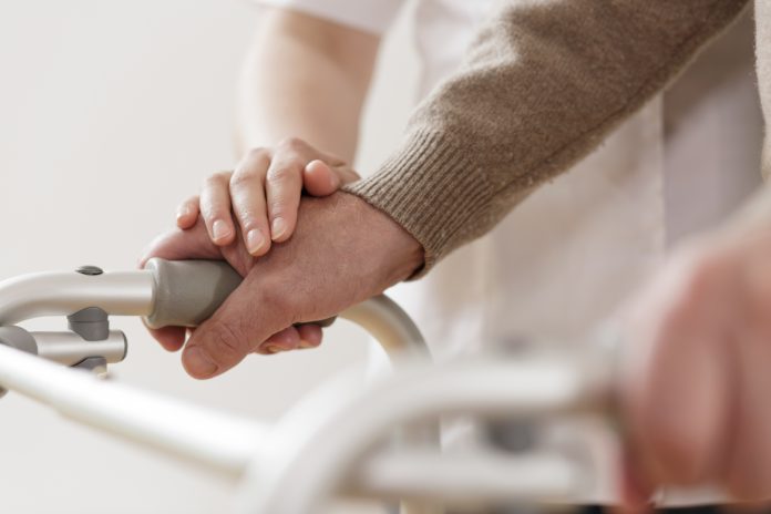 person assisting a patient with a disability