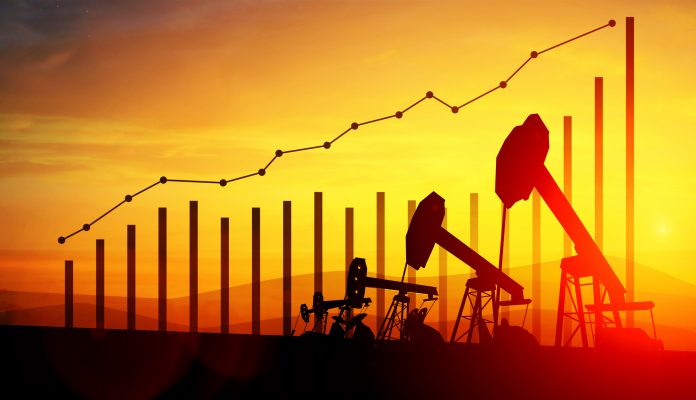 3d illustration of oil pump jacks on sunset sky background. Concept of growing oil prices