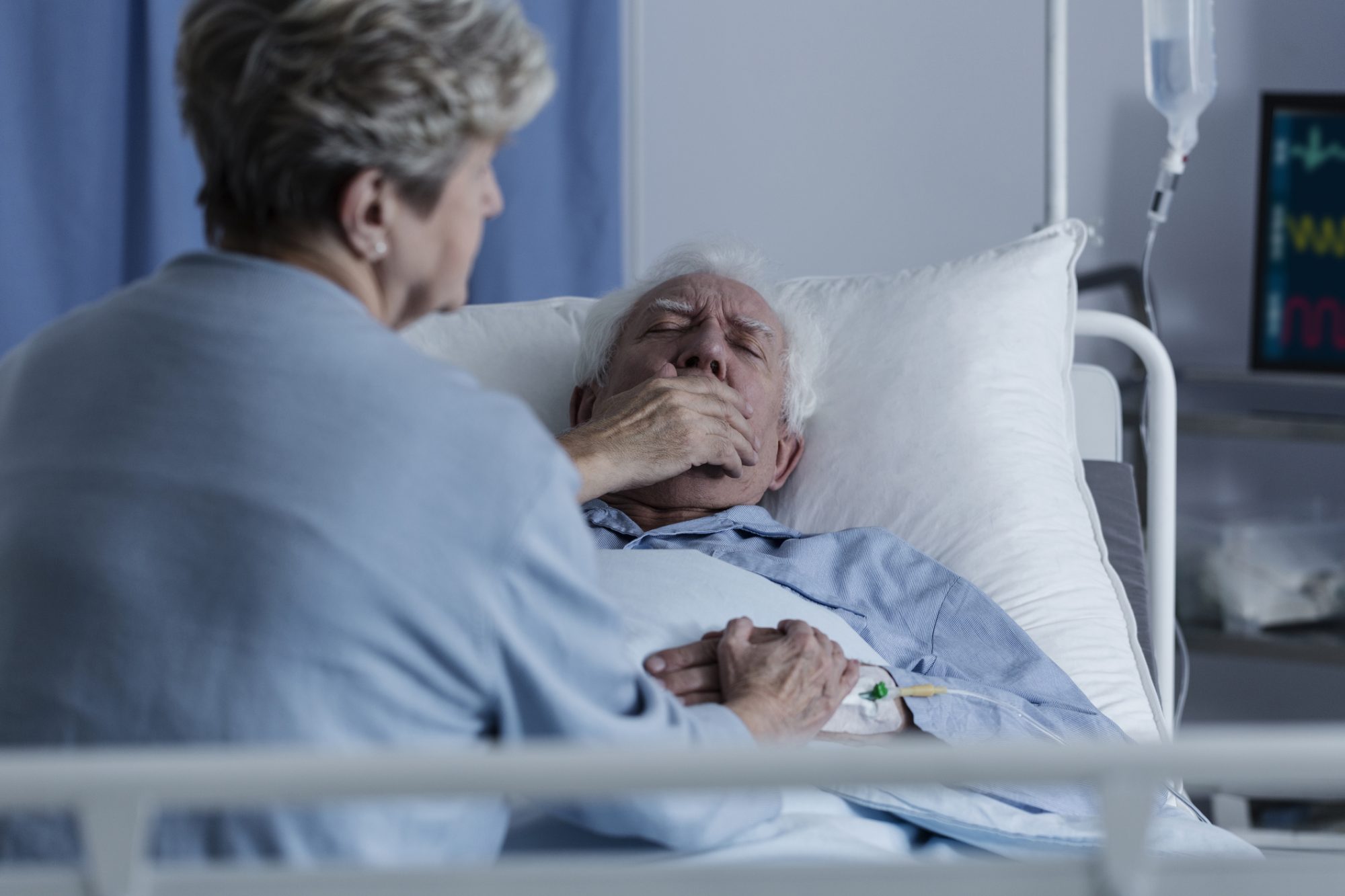 Elderly man in hospital bed with a lung condition