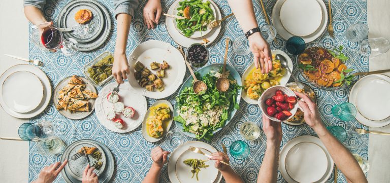 Mediterranean style dinner with various snacks and drinks, wide composition