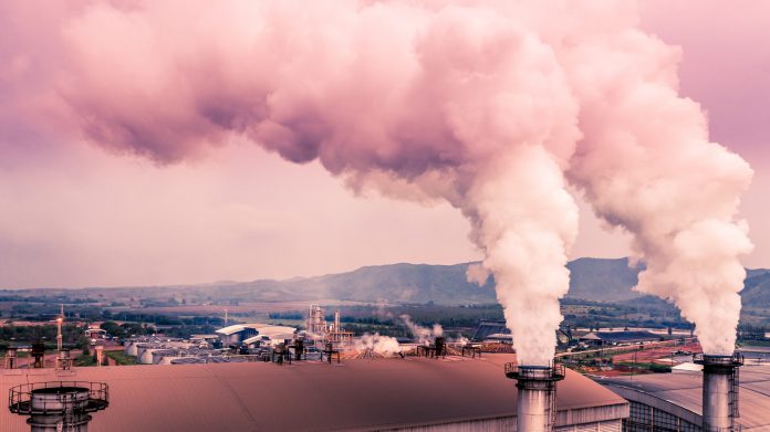 Smokestack pipe factory pollution in the city, Fuel Power Plant Smokestacks Emit Carbon Dioxide Pollution.