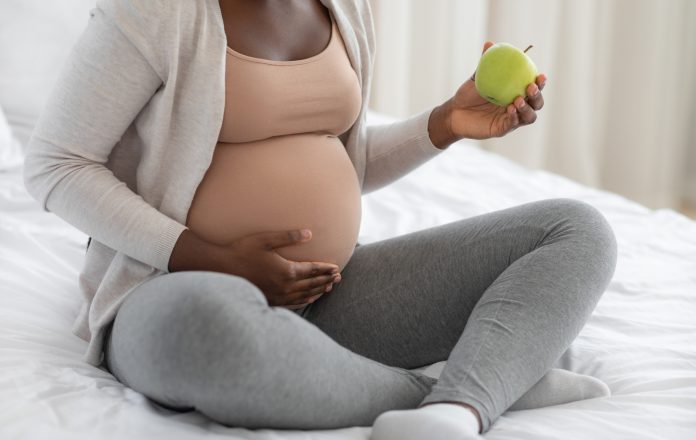 Pregnant woman eating food