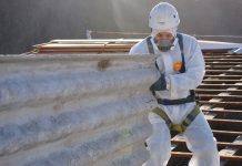 Professional worker removing asbestos roof