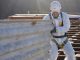 Professional worker removing asbestos roof