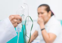 Doctor holding oxygen mask, Prepare inhaler for asthma patient.