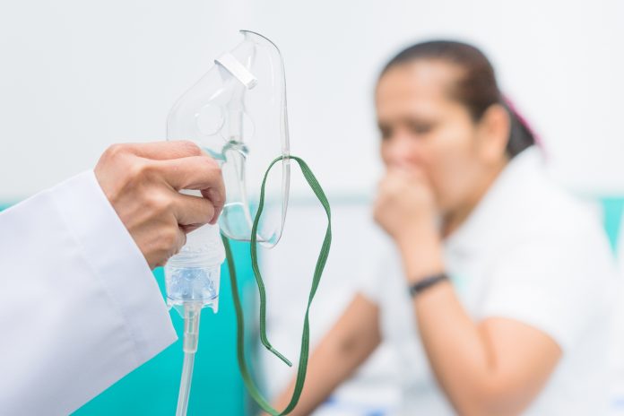 Doctor holding oxygen mask, Prepare inhaler for asthma patient.