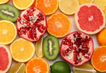 healthy food. mix sliced lemon, green lime, orange, mandarin, kiwi fruit and grapefruit isolated on white background