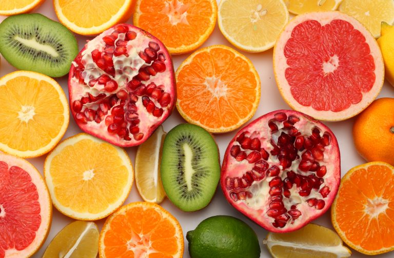 healthy food. mix sliced lemon, green lime, orange, mandarin, kiwi fruit and grapefruit isolated on white background