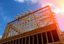 Timber house frame against blue sky