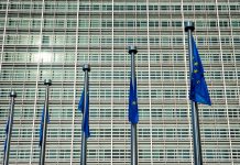 EU European Union flags in front of European Comission building in Background - horizon disagreements