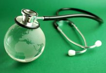 Stethoscope and crystal globe on green background, representing sustainable healthcare