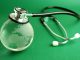 Stethoscope and crystal globe on green background, representing sustainable healthcare