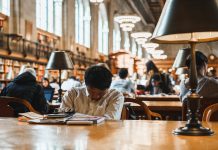 Student tired from thinking and studying in library in New York