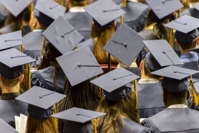 A group of graduating student wearing caps.