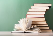 Open book, hardback books on wooden table. Education background