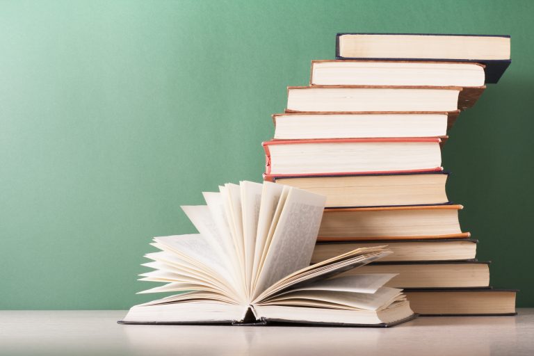 Open book, hardback books on wooden table. Education background