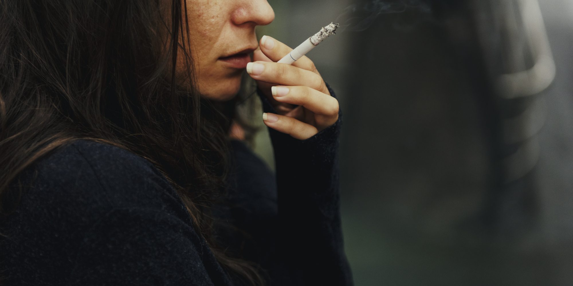 Young woman smoking cigarette