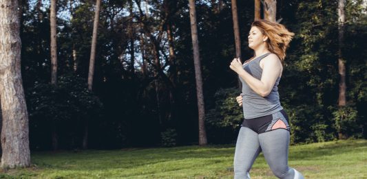 Caucasian woman wearing gym clothes running in order to lose weight