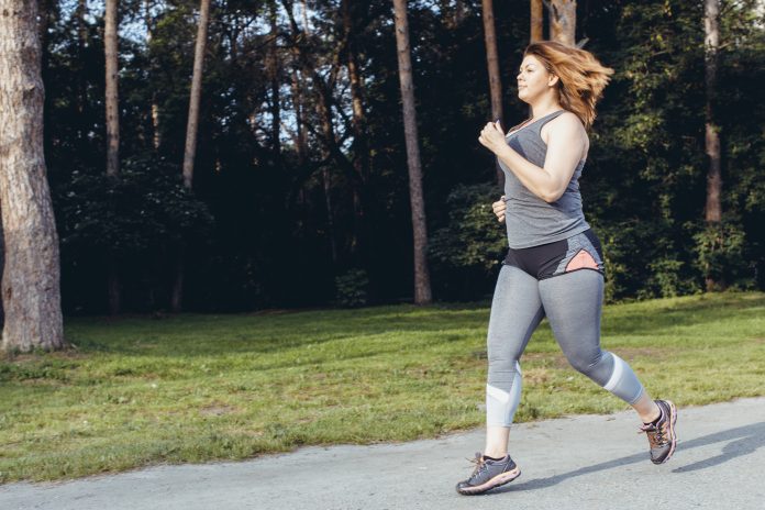 Caucasian woman wearing gym clothes running in order to lose weight