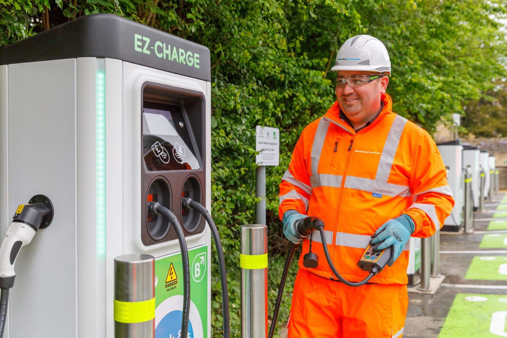 Volker highways worker with an electrical charging point