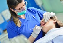 female dentist checking patient girl