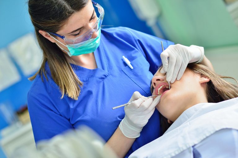 female dentist checking patient girl