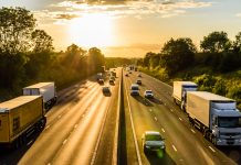 Busy traffic on uk motorway road overhead view at sunset