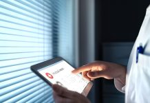 doctor using tablet to contact patient for medical record