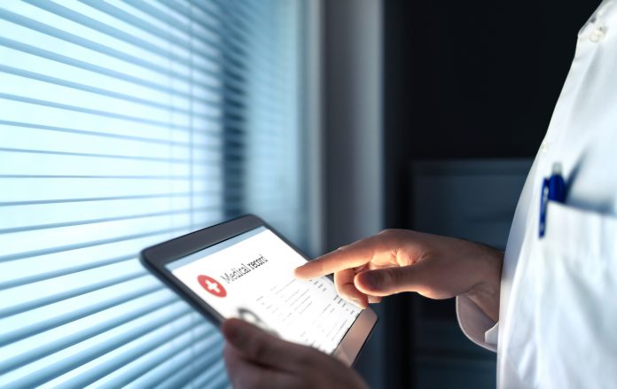 doctor using tablet to contact patient for medical record