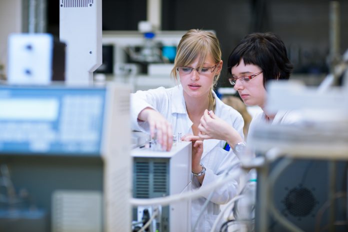 Females in a chemistry lab doing research